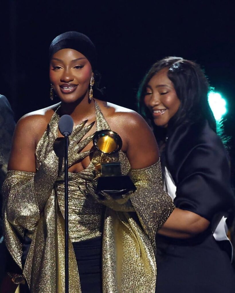 Tems receiving her grammy award